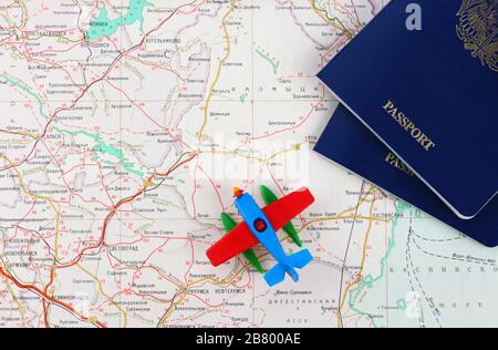 Concept de voyage. Morceaux de deux passeports bleus et un avion jouet sur une carte. Vue de dessus. Banque D'Images