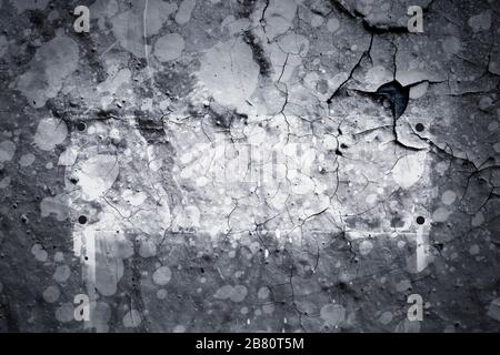 Texture de surface avec des éclaboussures grises de peinture sur une structure de surface fissurée d'un mur de béton avec un bouclier ou un cadre. Pour les arrière-plans abstraits. Allemand Banque D'Images