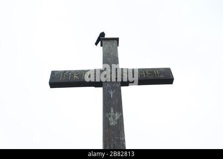 Crow était assis sur une croix. Untersberg, sommet Salzburger Hochthron, croix de sommet, Flachgau, Salzbourg, Autriche. Alpes de Berchtesgaden. Im Kreuz ist Heil. Banque D'Images