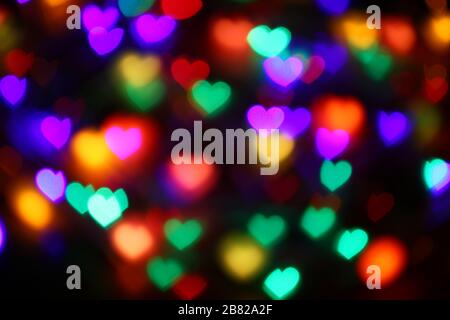 Valentines bokeh coloré en forme de coeur sur fond noir éclairage bokeh pour la décoration de nuit fond d'écran flou valentine, Love Pictures bac Banque D'Images