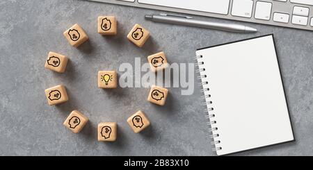 cubes montrant une séance de remue-méninges dans un espace de travail informatique moderne sur fond concret Banque D'Images