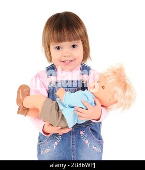 Petite fille en Jean combinaison marche et souriant sur fond blanc en studio photo. Beau concept de style de vie pour enfants heureux Banque D'Images