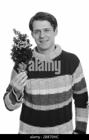 Happy handsome Young man holding Happy New Year tree Banque D'Images