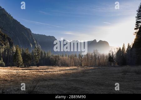 La lumière du soleil se lave à travers le fond de la vallée au coucher du soleil dans le parc national de Yosemite Banque D'Images