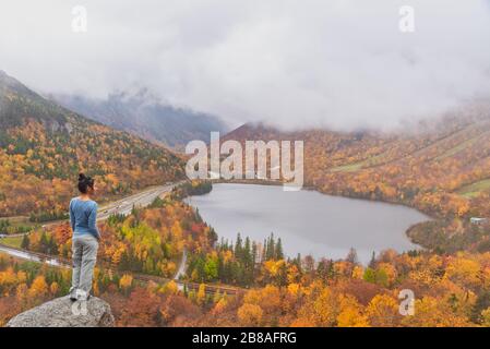 Femme se posant devant le magnifique lac Echo de Artists Bluff Loop dans le New Hampshire USA Banque D'Images