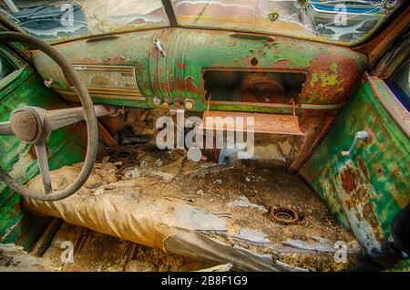 Intérieur de la vieille voiture déjuntée pleine de rouille et de déchets Banque D'Images