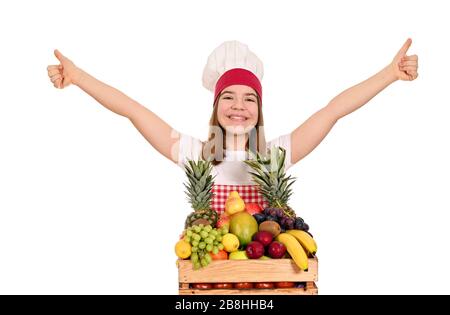 bonne cuisinière féminine avec fruits et pouces vers le haut Banque D'Images