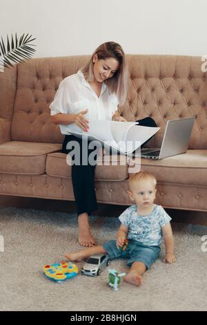 Belle femme d'affaires travail à domicile. Multi-tâches, missions et la maternité concept. Mère au travail carrière Banque D'Images