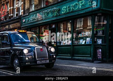 Boutique de livres originale de Soho, Londres, Royaume-Uni. Librairie à Londres. Taxi noir dans les rues de Londres Banque D'Images