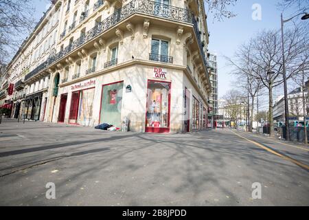 Un homme dort dans une rue vide Victoria près du Tour Saint-Jacques à Paris, France le 20 mars 2020. Paris est en verrouillage depuis mardi pour freiner la propagation du Coronavirus, les citoyens étant forcés de fournir une attestation, ou des documents administratifs, pour expliquer leur cause d'être à l'extérieur. (Photo de Daniel Brown/Sipa USA) Banque D'Images