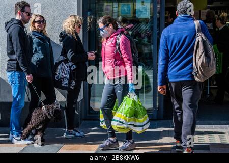 Les travailleurs reconnaissants et les retraités partent avec leurs achats - Waitrose à Clapham Junction est seulement ouvert aux travailleurs de NHS et les plus de 70 ans pour la première heure, donc une file d'attente de clients réguliers attend dehors - Anti Coronavirus (Covid 19) éclosion à Londres. Crédit: Guy Bell/Alay Live News Banque D'Images