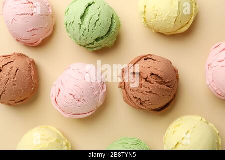 Boules de crèmes glacées sur fond beige, vue de dessus Banque D'Images