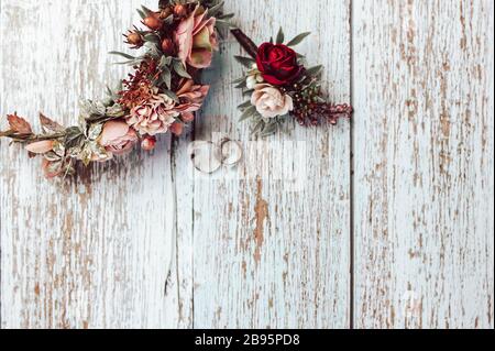 Ensemble de mariage romantique avec anneaux. Composition rustique de mariage de couple avec anneaux, couronne de fleur et boutonnière. Accessoires de mariage assortis. Banque D'Images