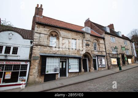 La maison de Jew est l'une des plus anciennes maisons de ville existantes en Angleterre. Il est situé sur la colline escarpée de Lincoln, juste en dessous du tribunal de Jew. La maison a traditionnellement été associée à la communauté juive prospère de Lincoln médiéval. L'hystérie antisémite a été attisée par un célèbre libelle de sang 1255, prétendant faussement le meurtre qu'un enfant, appelé petit Saint Hugh de Lincoln, a été rituellement tué par les juifs. En 1290, toute la communauté juive a été expulsée d'Angleterre, et la Maison du Juif aurait été saisie d'un propriétaire juif. Banque D'Images