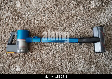 Aspirateur moderne avec piles sur fond beige doux Banque D'Images