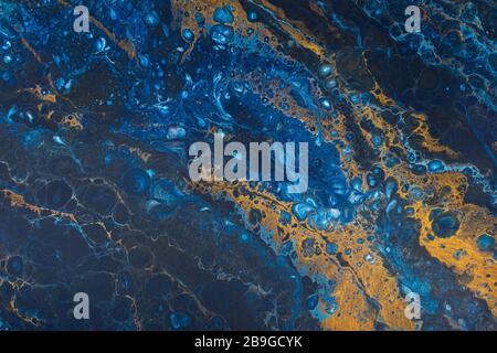 Mélange de bleu et d'or dans un modèle aléatoire comme l'huile dans l'eau Banque D'Images