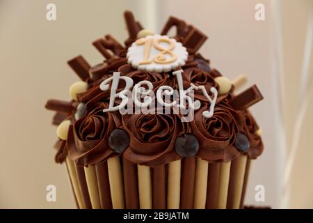 Un délicieux gâteau d'anniversaire au chocolat 18 en forme de cupcake, avec le mot Becky dessus Banque D'Images