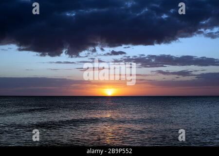 Le soleil descend sur le golfe du Mexique sur l'île Anna Maria, en Floride, aux États-Unis. Banque D'Images