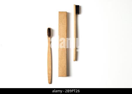 Concept écologique. Deux brosses à dents en bambou et une boîte isolée sur la vue de dessus blanche Banque D'Images
