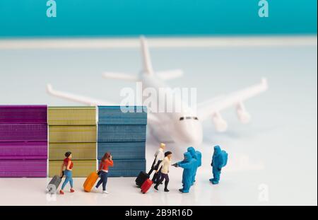 Images du concept de dépistage dans les aéroports de santé - figurines miniatures de jouets de l'agent d'inspection de santé dans des combinaisons bleues de risque biologique de hazmat pour le contrôle des passagers d'un Banque D'Images