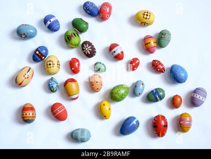 Sibiu, Roumanie - 18 mars 2020. Oeufs en bois multicolores sur fond blanc Banque D'Images