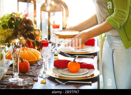 Femme servant de la tarte à la citrouille à la fête de Thanksgiving Banque D'Images