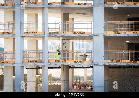 Manchester, Royaume-Uni. 25 mars 2020. Un ouvrier de la construction inspectant le sol par le sol d'un site opérationnel. Le Cabinet Office a confirmé que la construction en Angleterre peut se poursuivre tant qu'elle peut être effectuée en toute sécurité et en suivant les directives de Santé publique Angleterre. La sécurité des travailleurs de la construction a été largement controversée en raison de la propagation du coronavirus. Crédit : Andy Barton/Alay Live News Banque D'Images