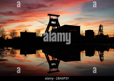 Herten, Allemagne. 25 mars 2020. La silhouette de l'ancienne mine Ewald peut être vue avant le coucher du soleil. Crédit: Marcel Kusch/dpa/Alay Live News Banque D'Images