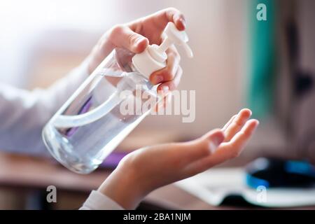 L'enfant désinfecte ses mains avec un désinfectant. Nouvelle épidémie Coronavirus 2019 nCoV. Mise au point sélective. Banque D'Images