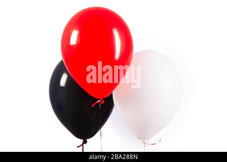 Trois bulles rouges, noires et blanches sur fond blanc Banque D'Images