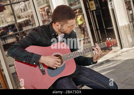 Charmant jeune musicien de rue avec guitare Banque D'Images