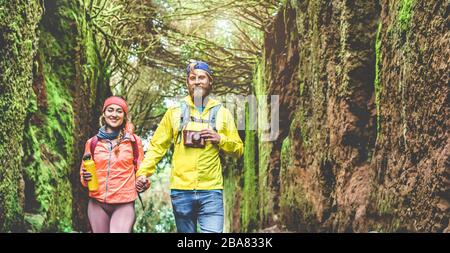 Jeune couple marchant à l'intérieur de la forêt pluvieuse - Hiker personnes s'amuser dans les bois - Voyage, découverte, trekking, vacances et concept de nature - Soft f Banque D'Images