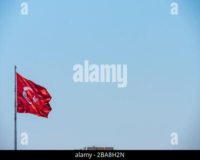 Drapeau turc qui agitant devant le ciel bleu. Contexte. Banque D'Images