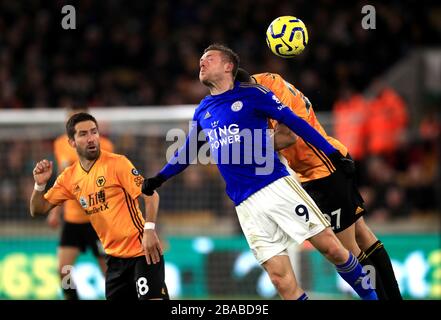 Jamie Vardy (centre) de Leicester City et Romain Saiss (droite) de Wolverhampton Wanderers combattent le ballon dans les airs Banque D'Images