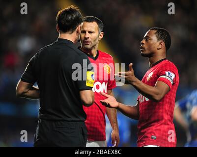 Ryan Giggs (centre) et Patrice Evra (droite) de Manchester United parlent avec l'arbitre Mark Clattenburg Banque D'Images