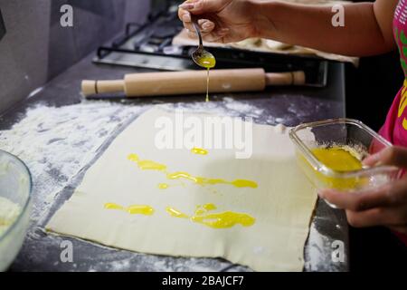 Faire cuire des petits pains avec du fromage. Mettre du fromage sur la pâte pour les petits pains Banque D'Images