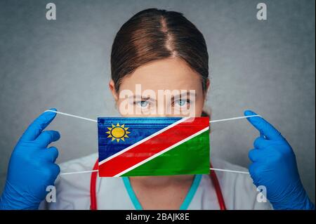 Coronavirus en Namibie Portrait de docteur féminin protège le masque médical chirurgical du visage avec le drapeau national de Namibie. Maladie, virus Covid-19 en Namibie, Banque D'Images