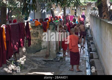 De jeunes moines bouddhistes prenant la douche avant le déjeuner dans le monastère de Mahagandayon, Mandalay, au Myanmar Banque D'Images