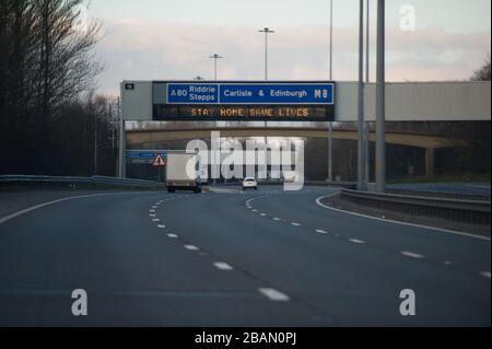 Glasgow, Royaume-Uni. 28 mars 2020. Sur la photo : des panneaux routiers tout le long des autoroutes M 8 et M 80 qui lisent : « RESTER À LA MAISON SAUVER DES VIES » la pandémie de Coronavirus a forcé le gouvernement britannique à ordonner la fermeture de toutes les grandes villes britanniques et à faire en sorte que les gens restent chez eux, ce qui a laissé les autoroutes et toutes les autres routes libres du nez habituel à la queue qui serait autrement là. Crédit : Colin Fisher/Alay Live News Banque D'Images