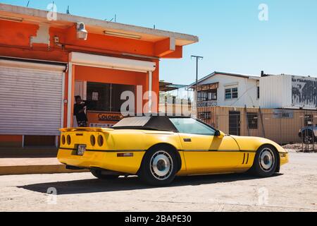 Une ancienne Chevrolet Corvette C4 jaune des années 1980 stationnée à Philipsburg, Saint-Martin Banque D'Images