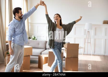 Heureux jeune homme barbu tenant la main, se tordant joyeuse épouse. Banque D'Images