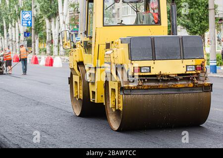 Melitopol, Ukraine, date du 27 mai 2017. La patinoire comcompacte la surface de la route, la réparation de la route dans la rue de la ville Banque D'Images