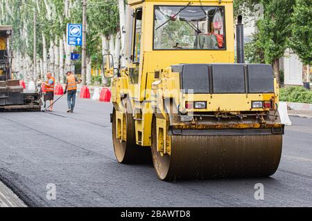 Melitopol, Ukraine, date du 27 mai 2017. La patinoire comcompacte la surface de la route, la réparation de la route dans la rue de la ville Banque D'Images