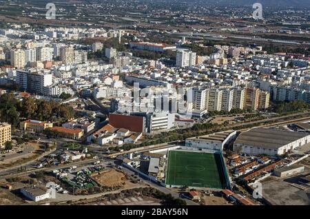 Vue aérienne de Faro sur la côte de l'Algarve au Portugal avec l'Escola de Futebol, école de football au premier plan. Banque D'Images