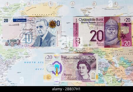Notes bancaires du Royaume-Uni montrant des notes de l'Irlande du Nord, de l'Ecosse et de l'Angleterre sur une carte du monde Banque D'Images