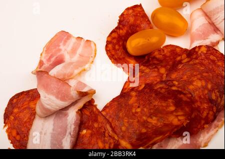 Tranches de saucisses, bacon et tomates sur fond blanc. Gros plan Banque D'Images