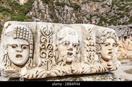 Old Stone les masques utilisés dans le théâtre d'acteurs dans les tombeaux de roche dans Myra ancienne ville d'Antalya en Turquie. Banque D'Images