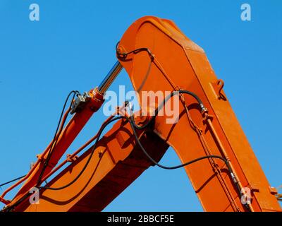 détail de la fermeture des bras de la machine hydraulique en acier. couleur orange. flexibles en caoutchouc pour fluides hydrauliques haute pression, bouteilles et tubes. industrie de la construction Banque D'Images