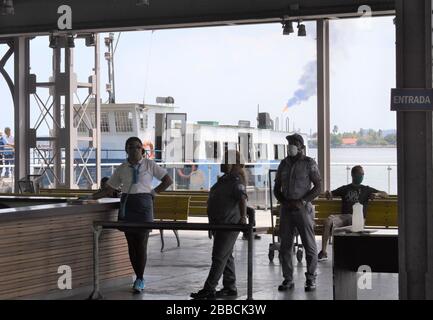 La Havane, Cuba. 30 mars 2020. Le personnel de sécurité portant des masques travaille à un terminal de ferry à la Havane, Cuba, le 30 mars 2020. Crédit: Zhu Wanjun/Xinhua/Alay Live News Banque D'Images