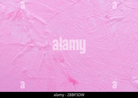 La texture de la paroi et du fond de la structure rose robuste. Peinture murale inégale de l'aquarelle sur un sol en bois. Banque D'Images